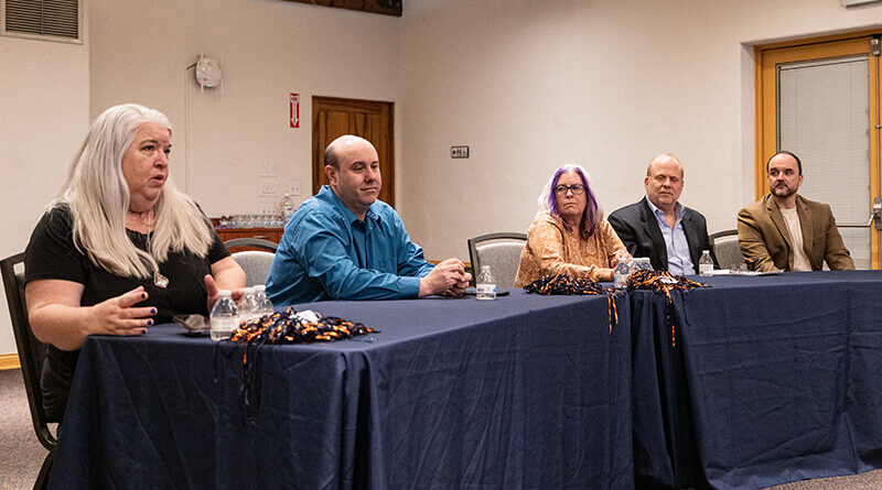 Four faculty members sit at the table for the interview