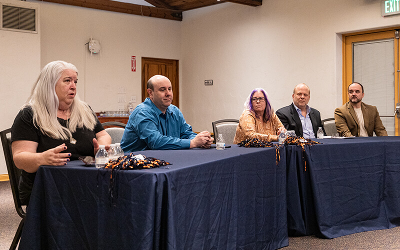 Four faculty members sit at the table for the interview